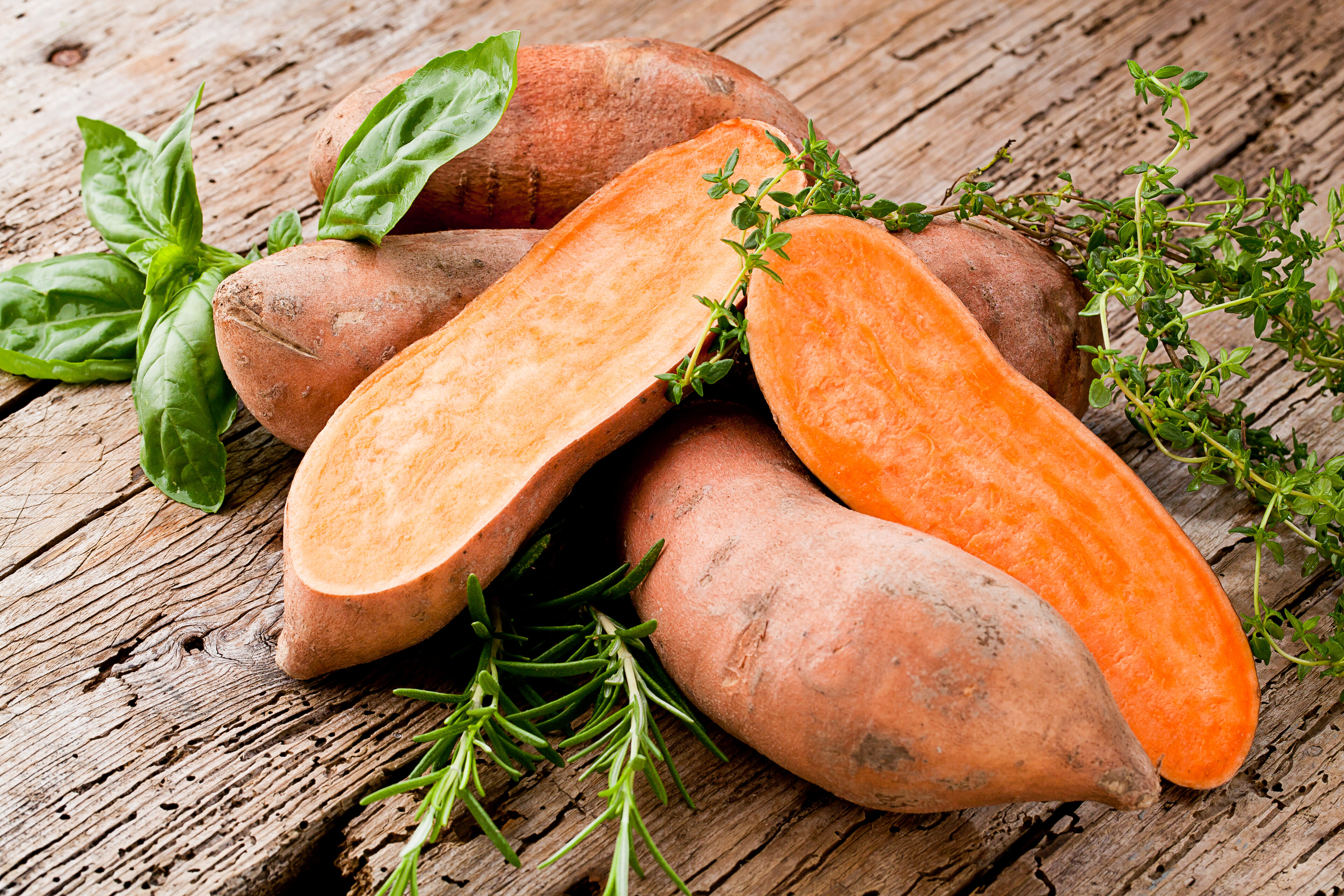 Sweet potatoes on a wooden background