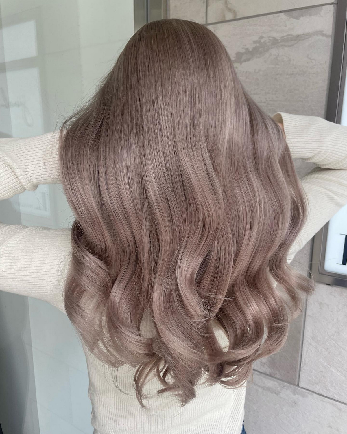The back of the girl with pink balayage hair floating and seductive