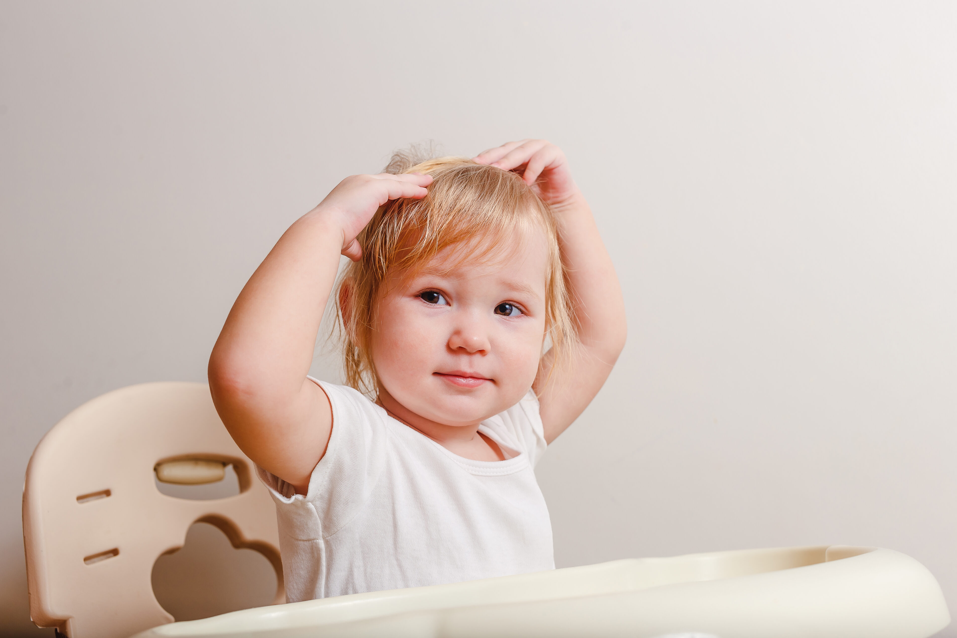 Baby girl is touching her hair