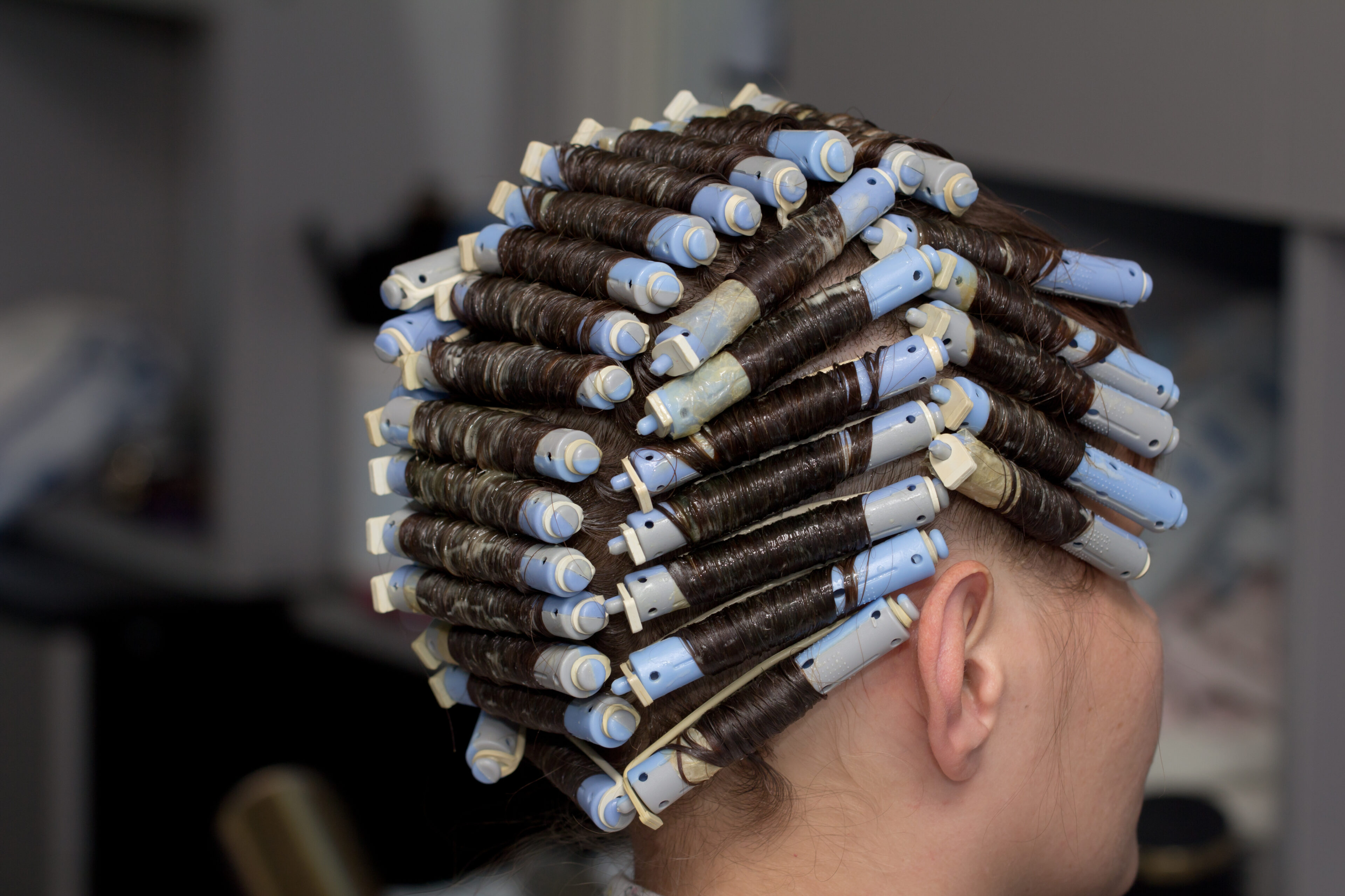 Start wrapping the hair around the perm rod
