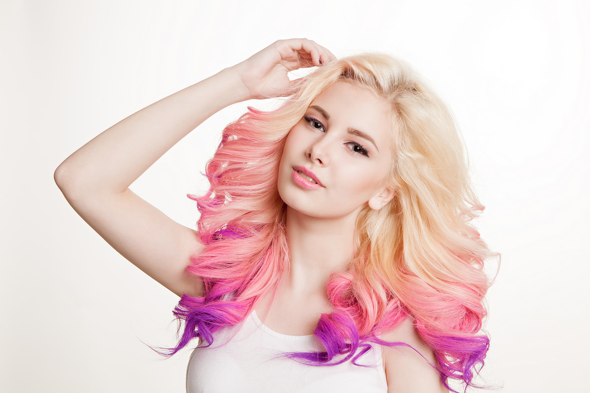 Youth women with colored curly hair on the white background