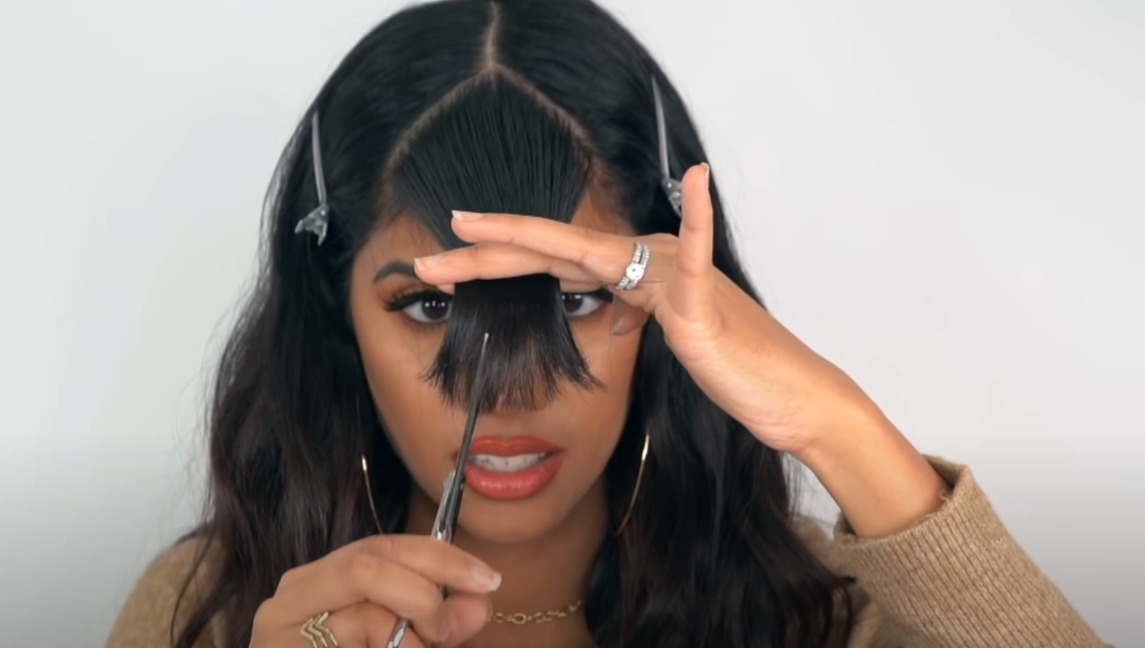 Use scissors to trim your bangs again