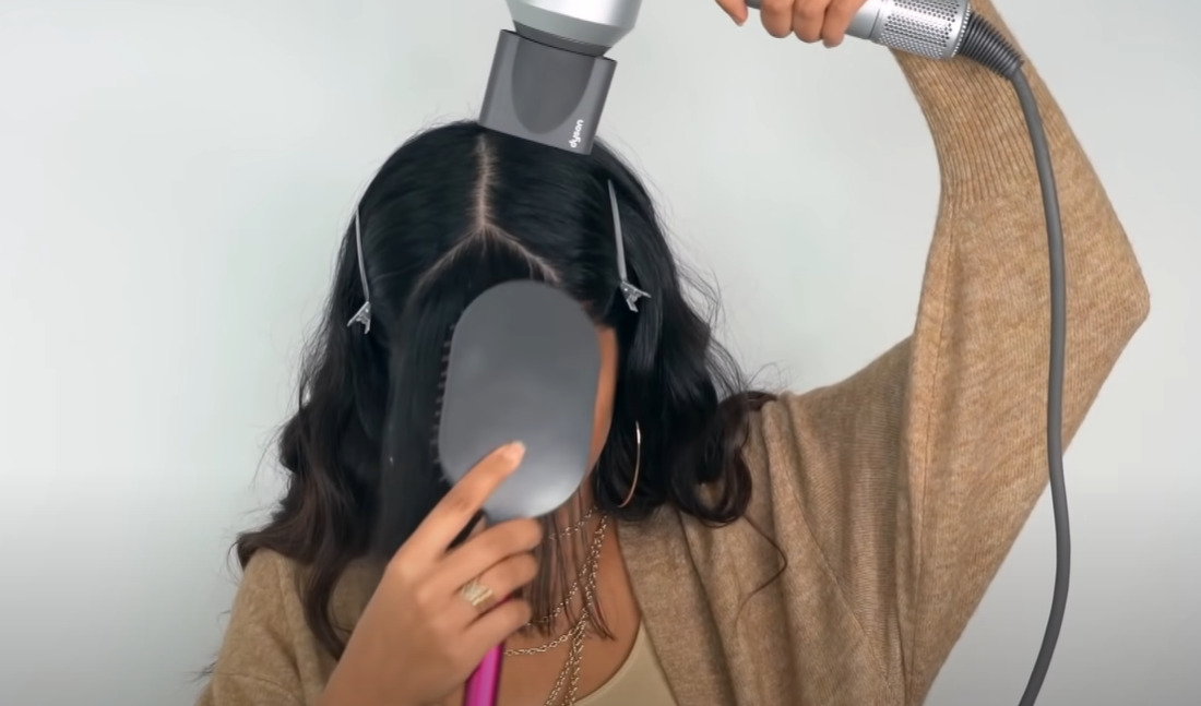 Use comb and dryer to style your curtain bangs