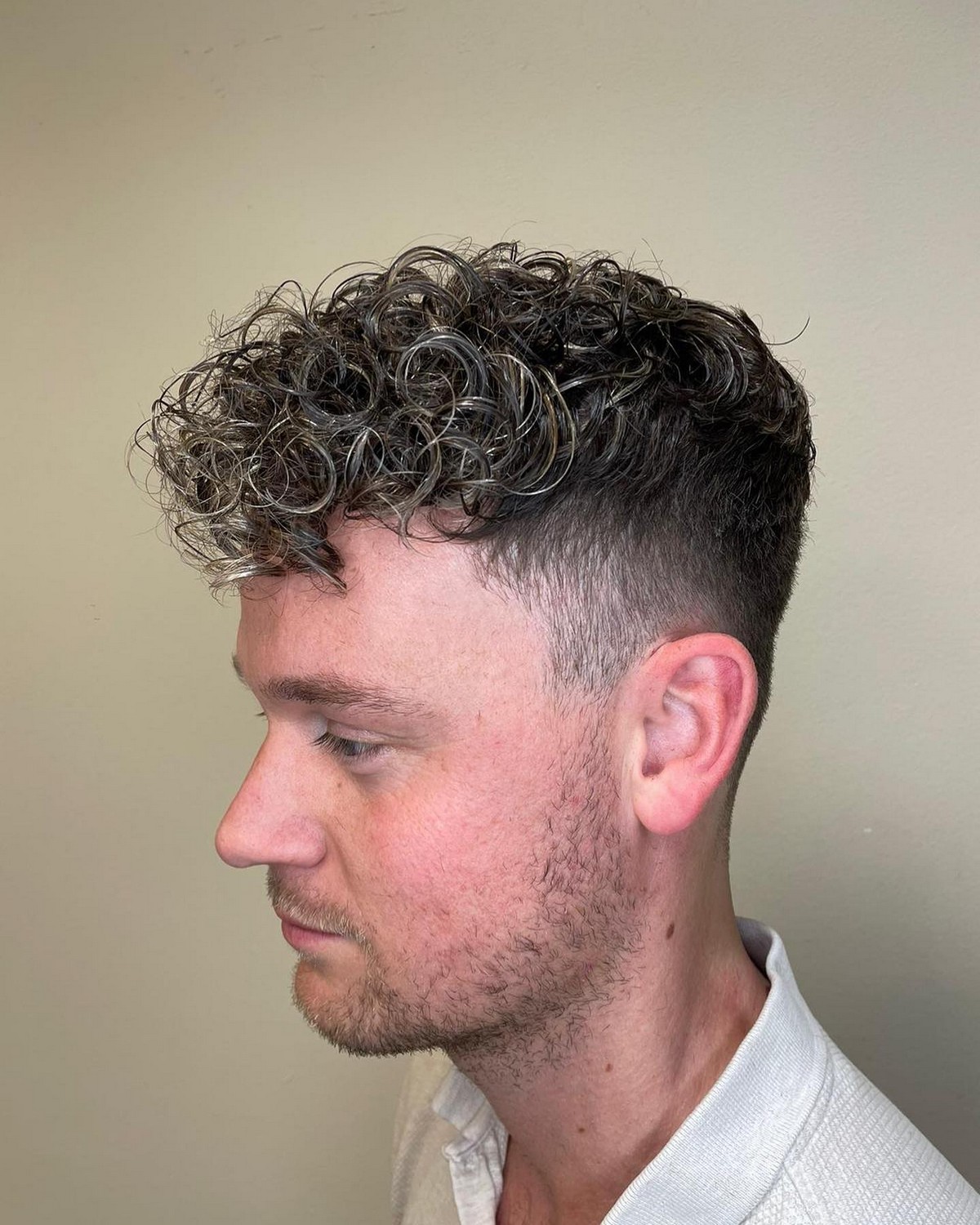 Long Curly Hair With Short Sides And Blonde Highlights 
