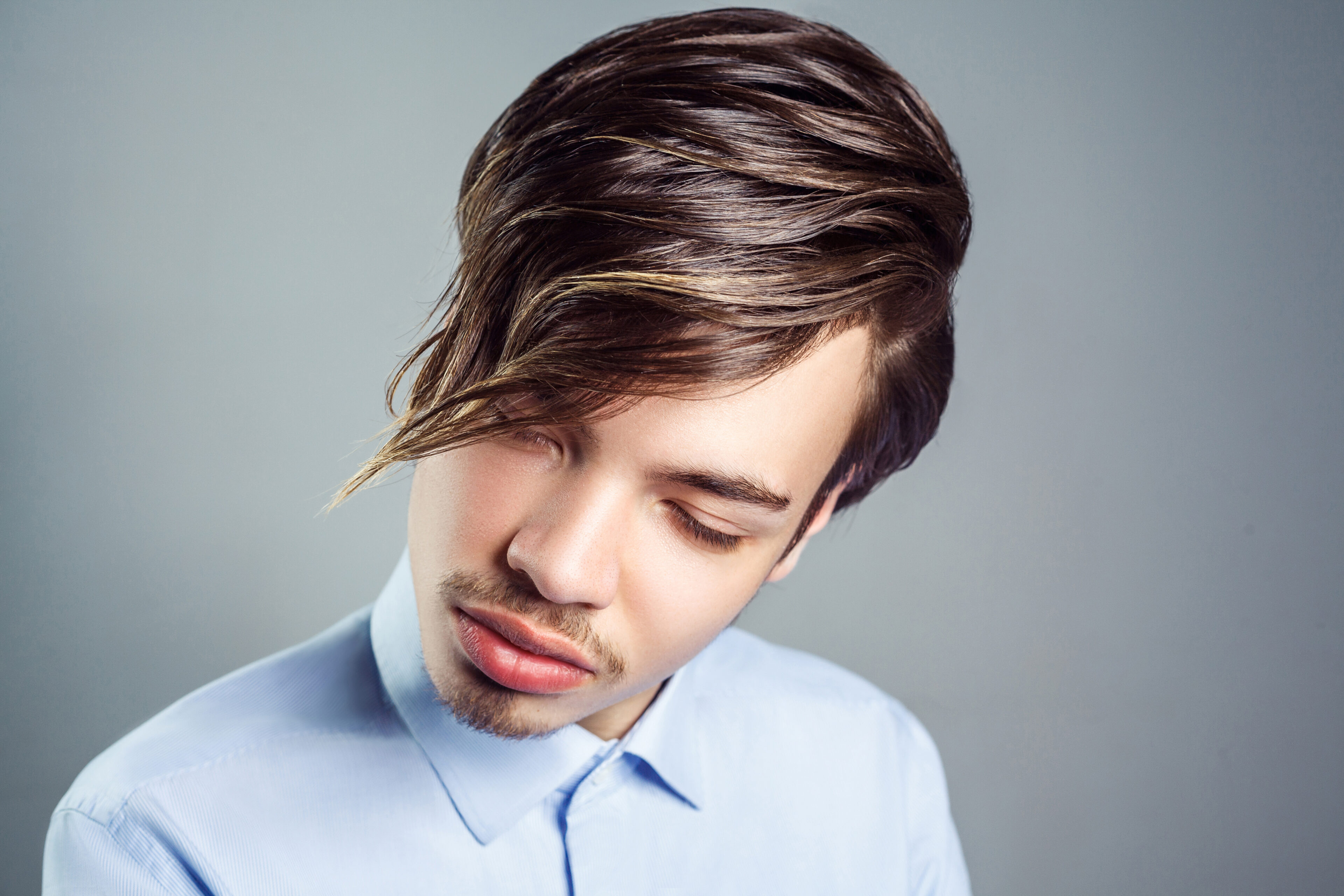 Deep side part with textured bangs