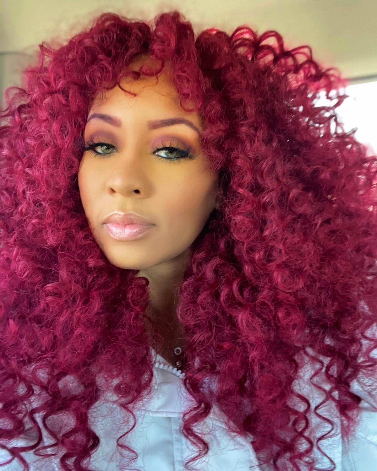 Voluminous Curls With Wispy Bangs