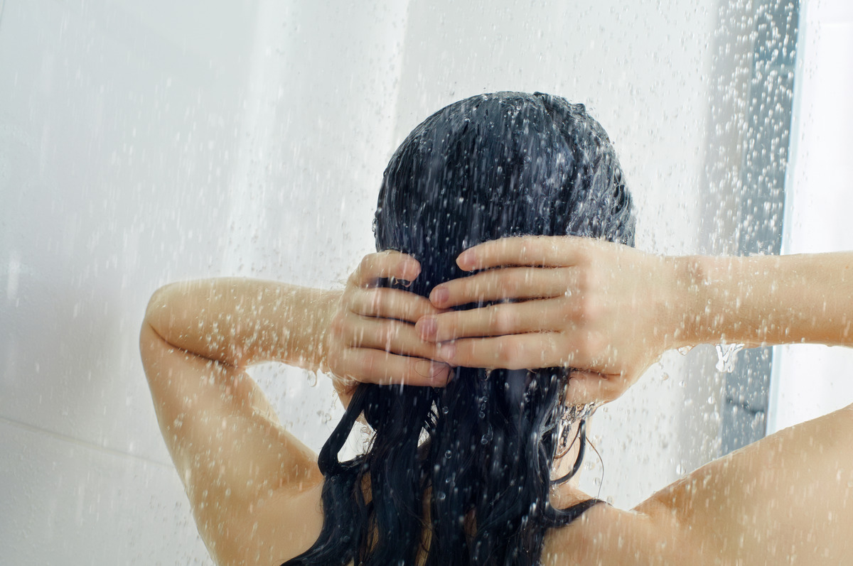 A beautiful girl standing in the shower