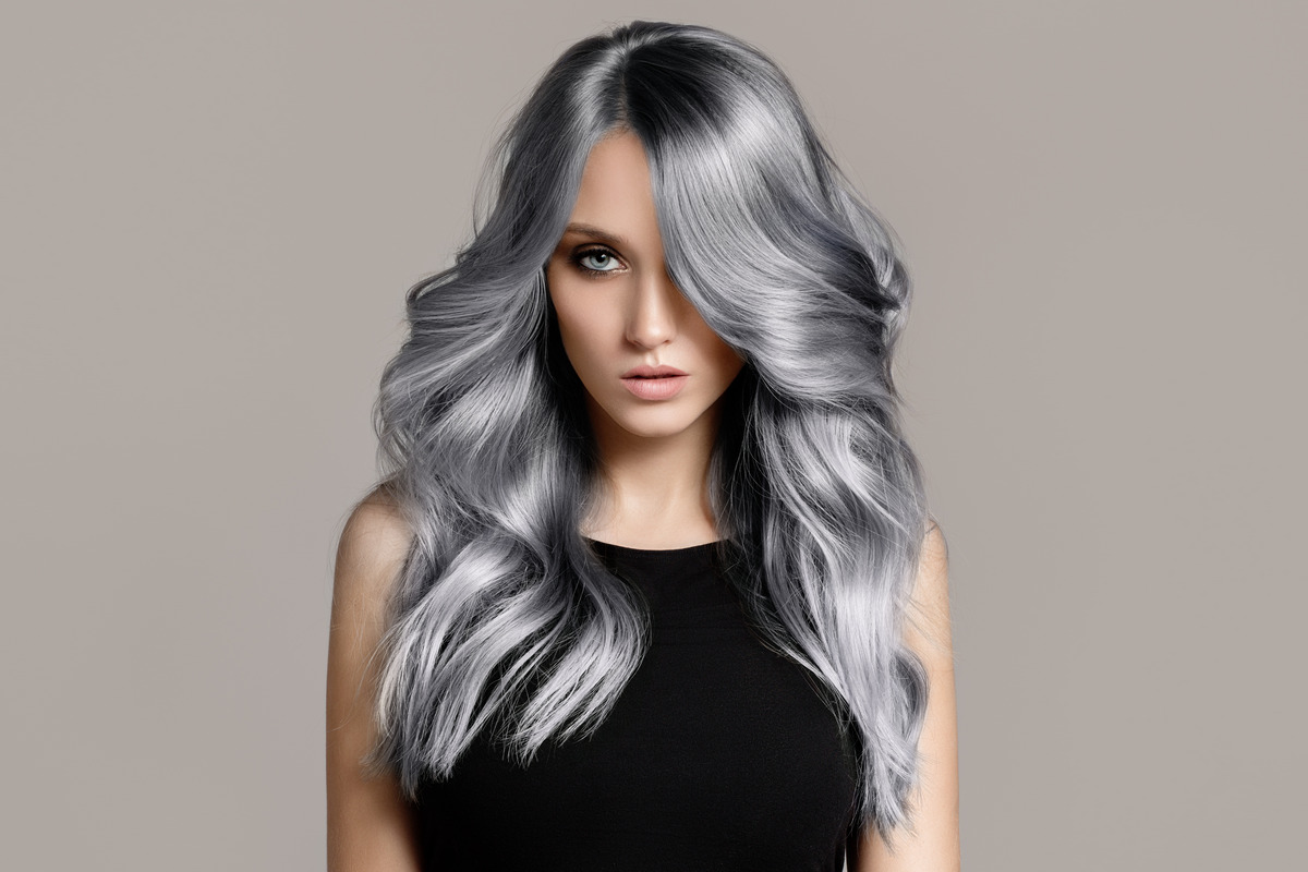 Beautiful woman with long uneven wavy colored hair