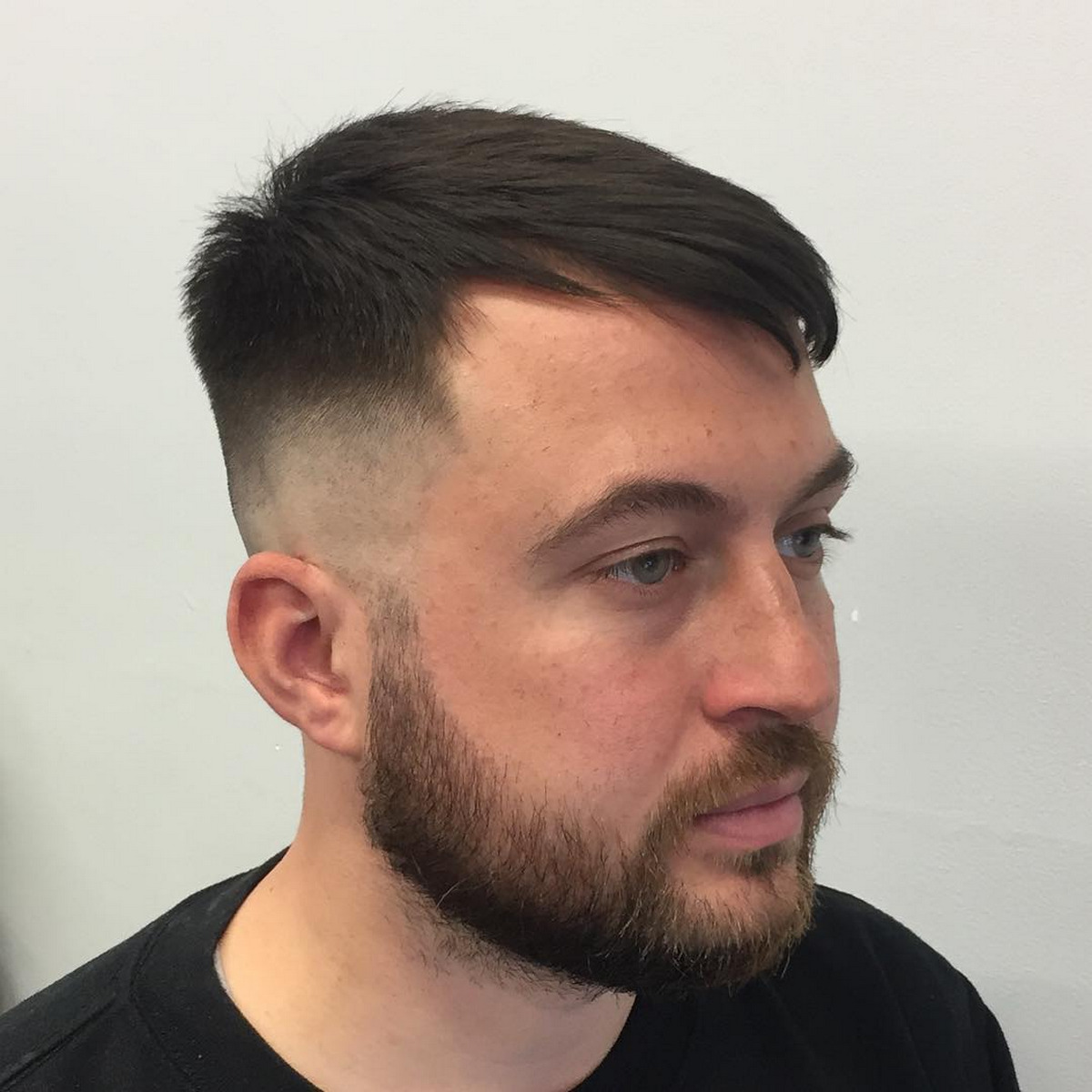 Brushed Forward Hairstyle With Mid Skin Fade 