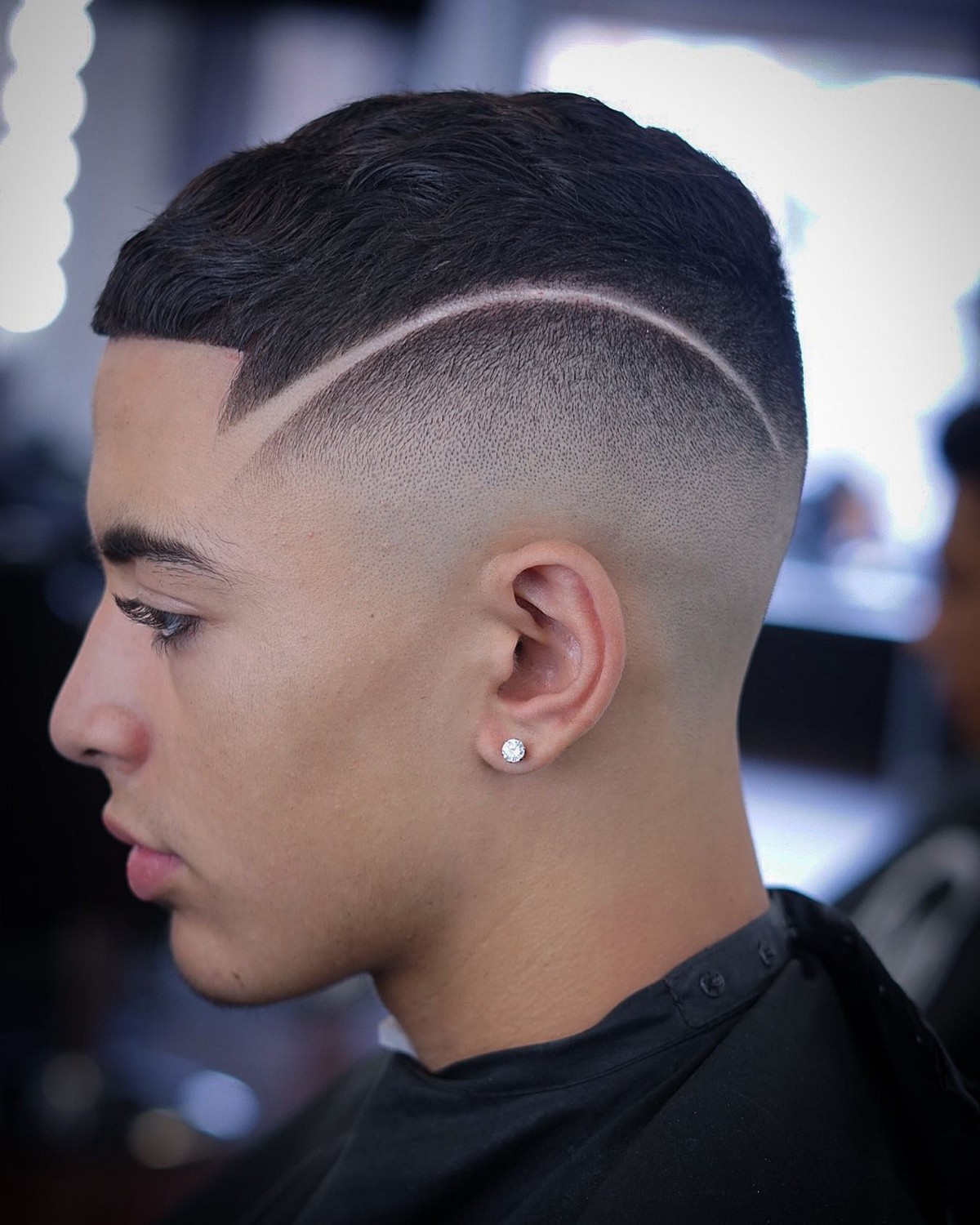 Man with high fade and haircut lines