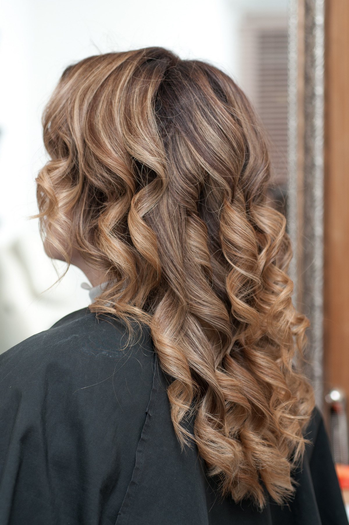 Hairstyle female curls on dark hair close up