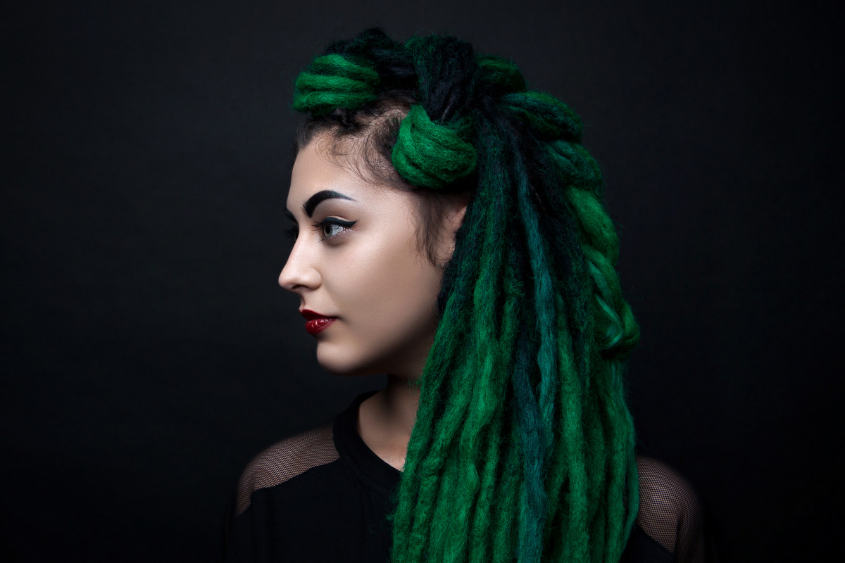 Pretty girl with green long dreadlocks