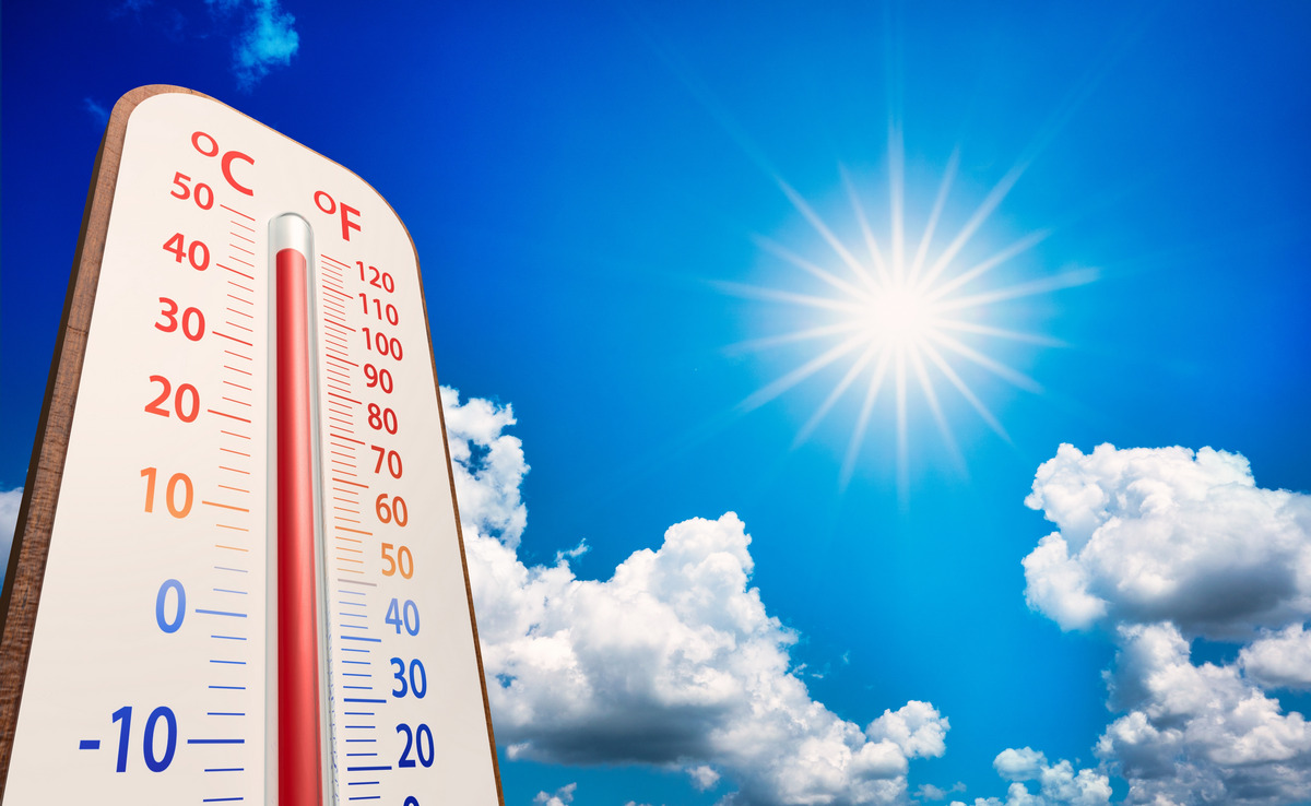 Thermometer on blue sky with sun shining in summer show higher weather