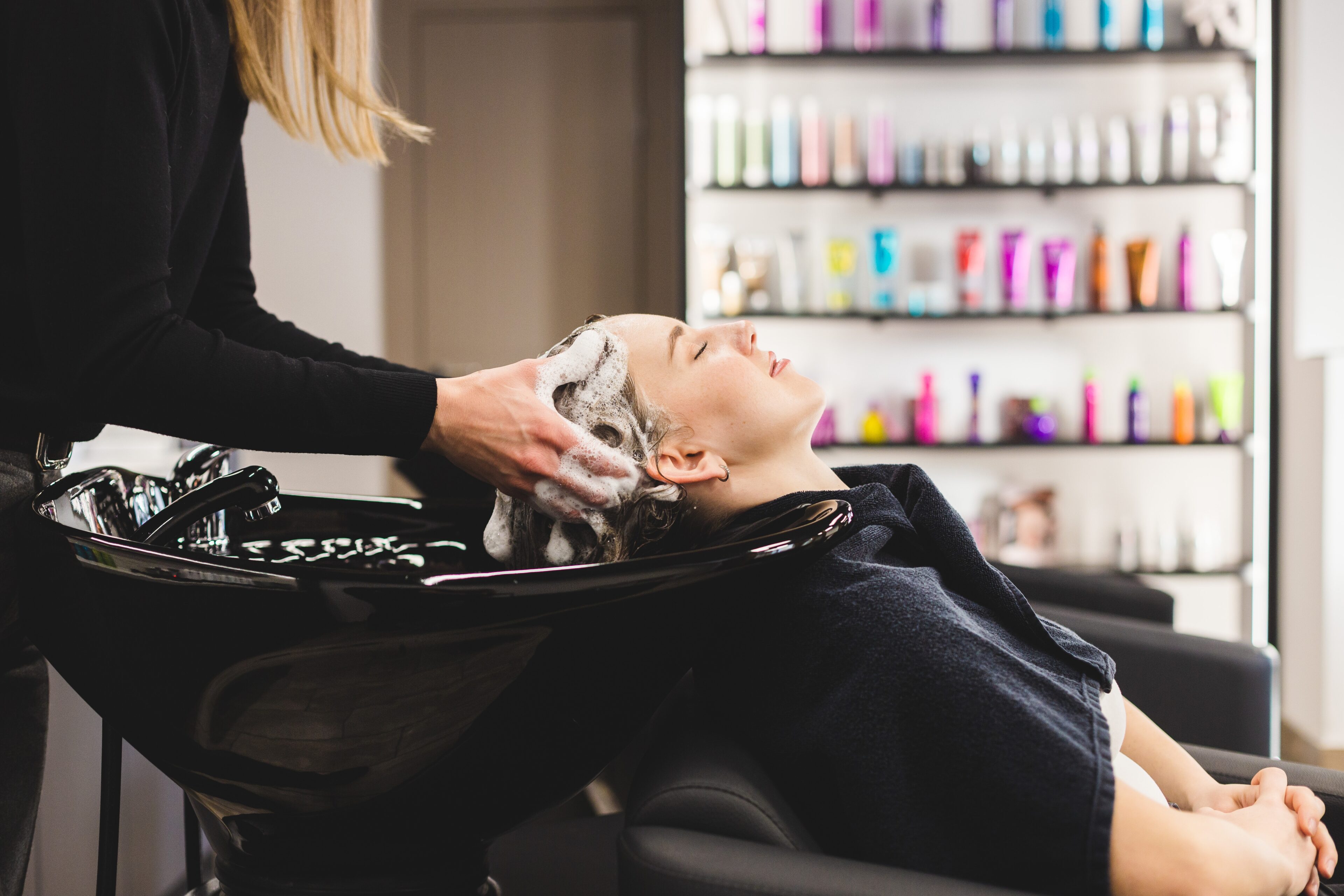 A girl is having her hair washed at a salon