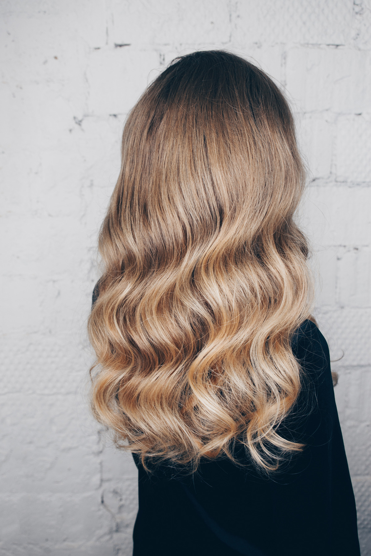 Young girl with hair styling - Hollywood wave in a black dress