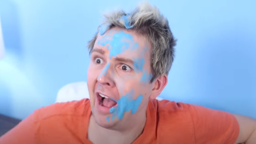 Image of a man with hair and face covered with paint