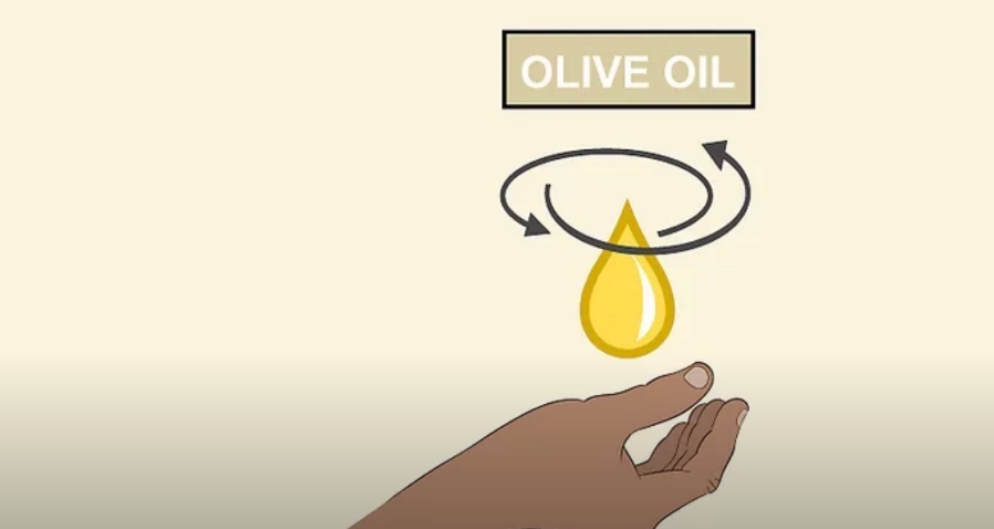Model of girl using olive oil to get paint out of hair