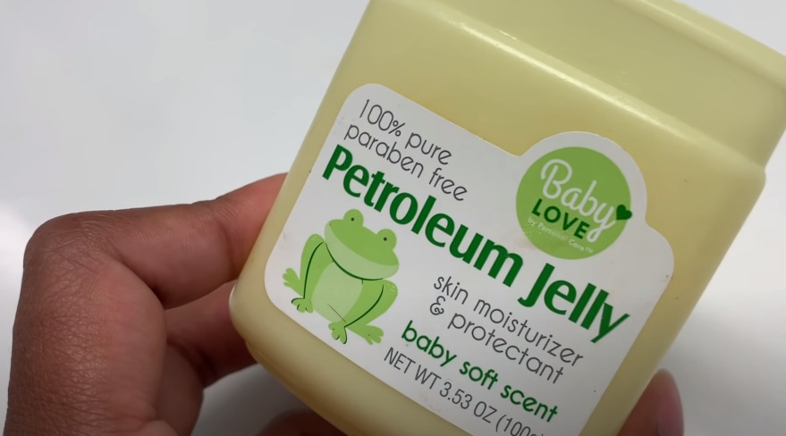 She is using petroleum jelly for hair