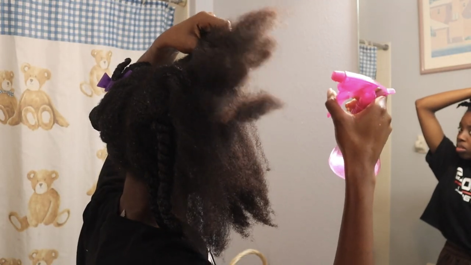 Split your hair and spray warm water to soften your locs before applying oil to moisturize your hair 
